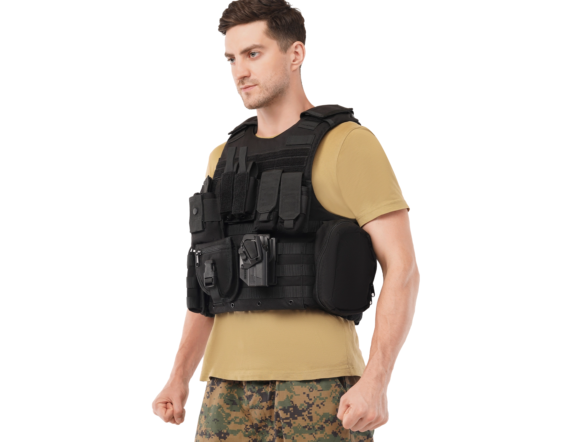 Man wearing Hard Shell Tactical Carrier – MRAP vest featuring modular pouches, holster attachment, and MOLLE webbing over a tan T-shirt and camouflage pants.